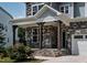 Inviting front porch with stone accents, wooden columns, and a charming black railing at 359 Abbot Pl, Chapel Hill, NC 27516