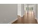 Hallway featuring hardwood floors, neutral paint, and a view of bright windows at 359 Abbot Pl, Chapel Hill, NC 27516