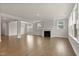 Bright living room showcases hardwood floors, a cozy fireplace, and large windows with natural light at 359 Abbot Pl, Chapel Hill, NC 27516