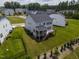 Aerial view of the backyard, showcasing a screened porch and a deck, surrounded by a well-manicured lawn at 359 Abbot Pl, Chapel Hill, NC 27516