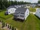 Aerial view showcasing the home's rear elevation with screened porch and deck, nestled in a landscaped backyard at 359 Abbot Pl, Chapel Hill, NC 27516
