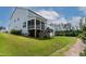 Rear exterior of home, featuring a screened porch and deck combination overlooking a well-maintained lawn at 359 Abbot Pl, Chapel Hill, NC 27516