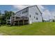 Spacious backyard featuring a screened porch, wood deck, and lush green lawn, perfect for outdoor living at 359 Abbot Pl, Chapel Hill, NC 27516