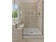 Modern tiled shower with bench seating and a seamless glass enclosure at 359 Abbot Pl, Chapel Hill, NC 27516