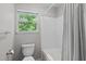 Bathroom with a toilet, a shower-tub combo and a small window at 405 Gooseneck Dr # B6, Cary, NC 27513