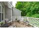Cozy outdoor deck with chairs, white lattice railing, and serene views of the surrounding trees at 405 Gooseneck Dr # B6, Cary, NC 27513