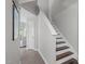 Hallway view with stairway, gray walls and laminate floor at 405 Gooseneck Dr # B6, Cary, NC 27513