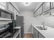 Bright kitchen with stainless steel appliances and quartz countertops at 405 Gooseneck Dr # B6, Cary, NC 27513