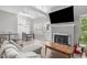 Open concept living room featuring vaulted ceilings, fireplace, and laminate floor at 405 Gooseneck Dr # B6, Cary, NC 27513