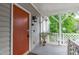 Exterior porch featuring seating area, privacy lattice, and painted front door at 405 Gooseneck Dr # B6, Cary, NC 27513