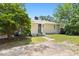 Cozy home featuring a charming backyard with mature trees and a small patio at 407A Edward St, Durham, NC 27701