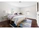 Cozy bedroom with natural light, hardwood floors, and minimalist decor at 407A Edward St, Durham, NC 27701