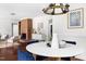 Dining area with hardwood floors, modern chandelier, and an open view to the living room at 407A Edward St, Durham, NC 27701