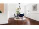 Cozy dining area with a round table, four chairs, hardwood floors, and natural light at 407A Edward St, Durham, NC 27701