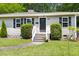 Charming home featuring a welcoming front entrance with well-maintained landscaping and stylish front door at 407A Edward St, Durham, NC 27701