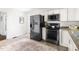 Bright kitchen showcasing stainless steel appliances, and white cabinets at 407A Edward St, Durham, NC 27701