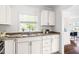 Bright kitchen with granite countertops, stainless steel sink, and ample cabinet space at 407A Edward St, Durham, NC 27701