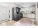 Bright kitchen featuring stainless steel appliances, white cabinets, and tiled floors at 407A Edward St, Durham, NC 27701