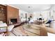 Bright living room with hardwood floors, a decorative fireplace, and an open dining area at 407A Edward St, Durham, NC 27701