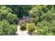 This aerial shot shows a brick home nestled among mature trees in a residential neighborhood at 4200 Marvin Pl, Raleigh, NC 27609