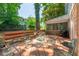 Outdoor living with a stained wooden deck and seating amidst mature trees and greenery at 4200 Marvin Pl, Raleigh, NC 27609