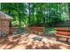 A well-maintained backyard featuring a wooden deck with seating and mature trees at 4200 Marvin Pl, Raleigh, NC 27609