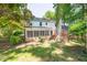 This beautiful backyard showcases mature trees, a brick house, and an inviting screened-in porch at 4200 Marvin Pl, Raleigh, NC 27609