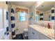 Bright bathroom featuring a tub/shower, vanity with storage, and charming decor at 4200 Marvin Pl, Raleigh, NC 27609