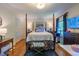 Bright bedroom with a four-poster bed, hardwood floors, and an abundance of natural light at 4200 Marvin Pl, Raleigh, NC 27609