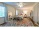 Comfortable bedroom featuring natural light, a ceiling fan, and a spacious closet at 4200 Marvin Pl, Raleigh, NC 27609