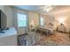 Well-lit bedroom featuring a ceiling fan, large windows, and hardwood flooring at 4200 Marvin Pl, Raleigh, NC 27609