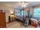 Bedroom with ceiling fan, golf bag, and natural light from two windows at 4200 Marvin Pl, Raleigh, NC 27609