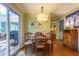 Charming dining area with access to the outdoor patio and a stylish light fixture at 4200 Marvin Pl, Raleigh, NC 27609