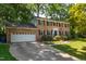 Charming two-story brick home with attached garage and a lush, landscaped front yard at 4200 Marvin Pl, Raleigh, NC 27609