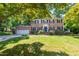 Charming two-story brick home with attached garage and a lush, landscaped front yard at 4200 Marvin Pl, Raleigh, NC 27609