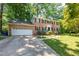 Charming two-story brick home with attached garage and a lush, landscaped front yard at 4200 Marvin Pl, Raleigh, NC 27609