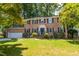 Charming two-story brick home with attached garage and a lush, landscaped front yard at 4200 Marvin Pl, Raleigh, NC 27609
