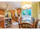 Eat-in kitchen area with a view to the backyard and stylish light fixture at 4200 Marvin Pl, Raleigh, NC 27609