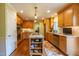 Well-equipped kitchen with a central island, stainless steel appliances, and custom cabinetry at 4200 Marvin Pl, Raleigh, NC 27609