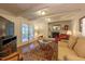 Inviting living room with fireplace, French doors, and a beautiful area rug at 4200 Marvin Pl, Raleigh, NC 27609