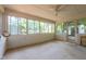 This light-filled sunroom features white brick walls and a ceiling fan for comfortable living at 4200 Marvin Pl, Raleigh, NC 27609