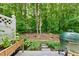 The backyard with a patio and a lush garden, perfect for relaxation and outdoor activities at 4353 Sugarbend Way, Raleigh, NC 27606