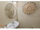Half bathroom with a modern round mirror and a stylish decorative wall piece at 4353 Sugarbend Way, Raleigh, NC 27606