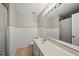 Well-lit bathroom featuring a large vanity with a white countertop and beadboard paneling at 4353 Sugarbend Way, Raleigh, NC 27606