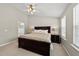 Primary bedroom featuring a large bed, nightstands, and a view of the ensuite bathroom at 4353 Sugarbend Way, Raleigh, NC 27606