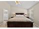 Vaulted ceiling primary bedroom featuring a large bed, and a view of the ensuite bathroom at 4353 Sugarbend Way, Raleigh, NC 27606