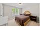 Bright bedroom with a large window and a cozy bed with two bedside tables at 4353 Sugarbend Way, Raleigh, NC 27606