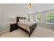 Vaulted ceiling primary bedroom featuring a large bed, windows, and ample natural light at 4353 Sugarbend Way, Raleigh, NC 27606
