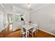 Bright dining area with marble table, wood floors, and open access to the kitchen at 4353 Sugarbend Way, Raleigh, NC 27606