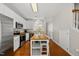 Open kitchen with white cabinets, stainless steel appliances, and an island at 4353 Sugarbend Way, Raleigh, NC 27606